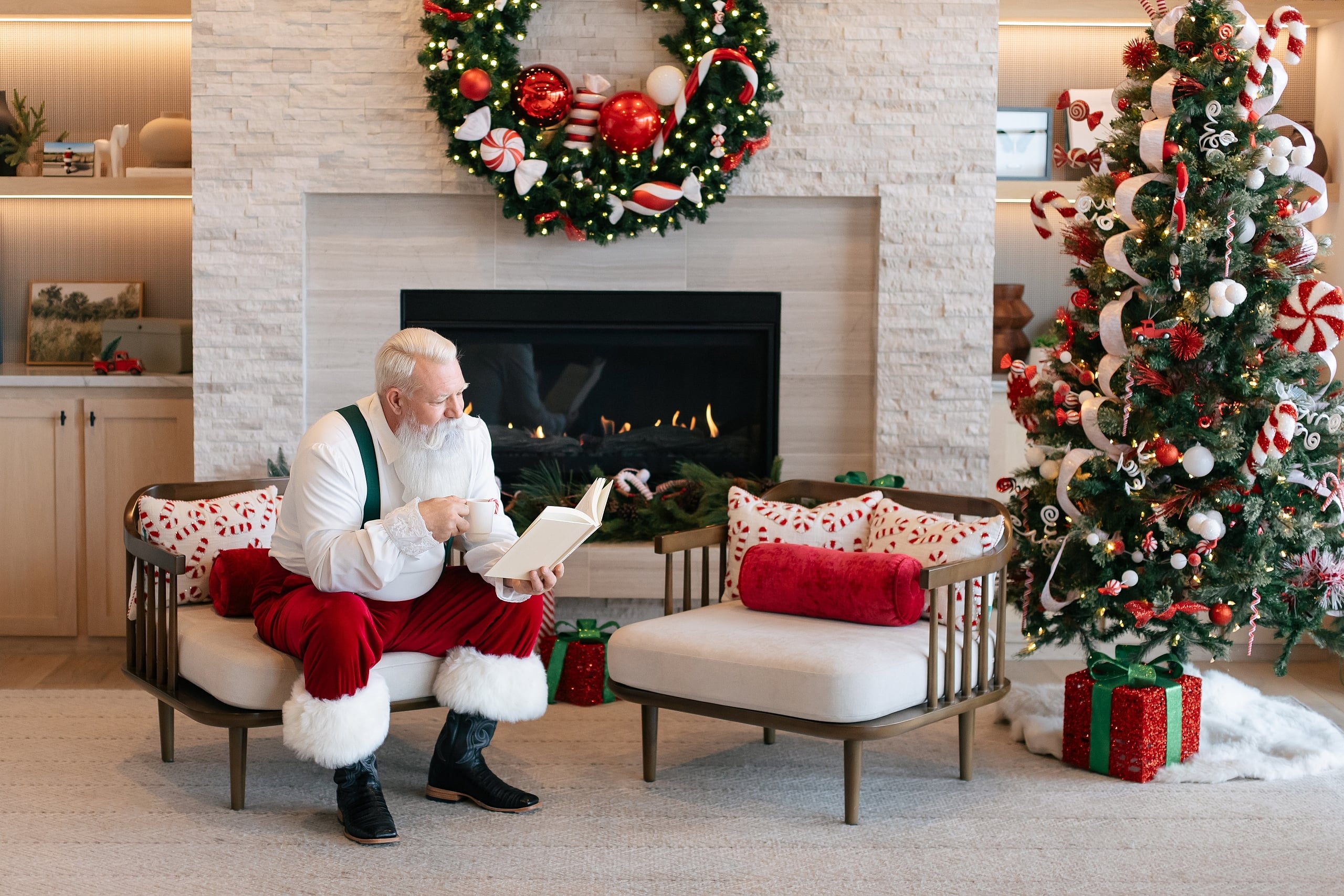 sitting in front of a holiday decorated room with a large fireplace in the background