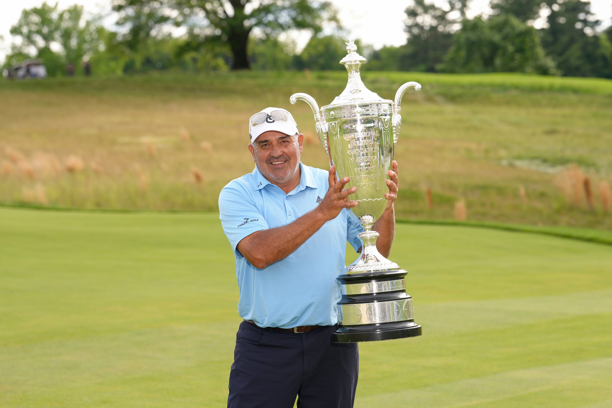 Angel Cabrera poses with the Alfred S. Bourne Trophy after winning the Senior PGA Championship at Congressional Country Club.