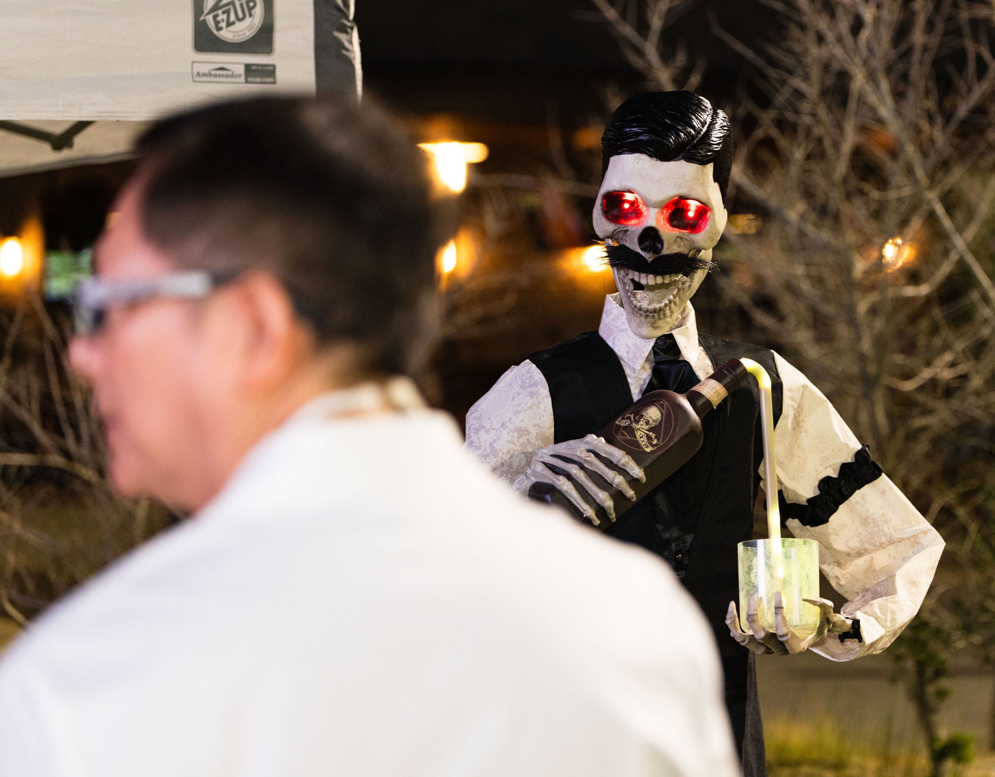 Skeleton bartender pouring drink