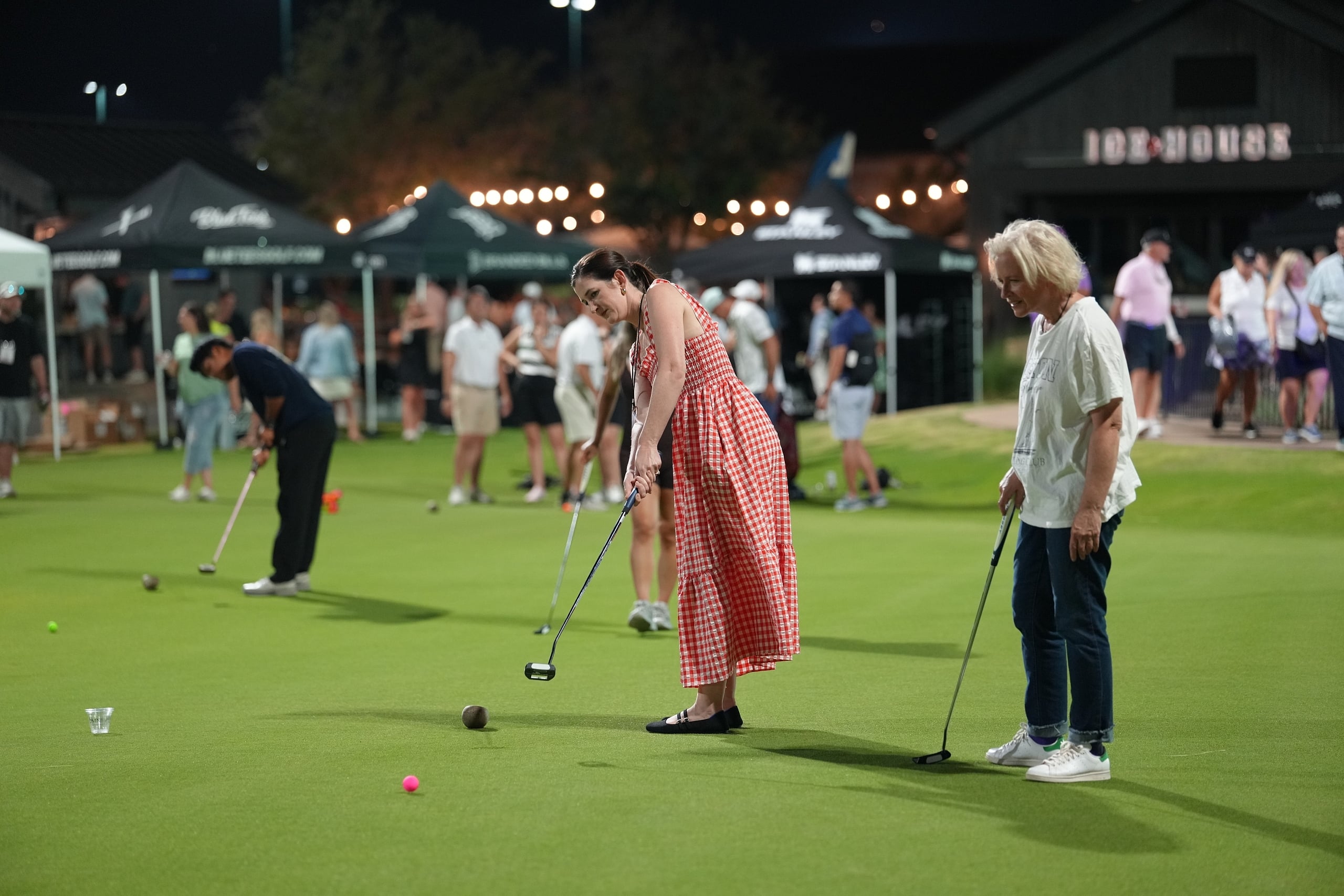 woman in red gingham dress putting