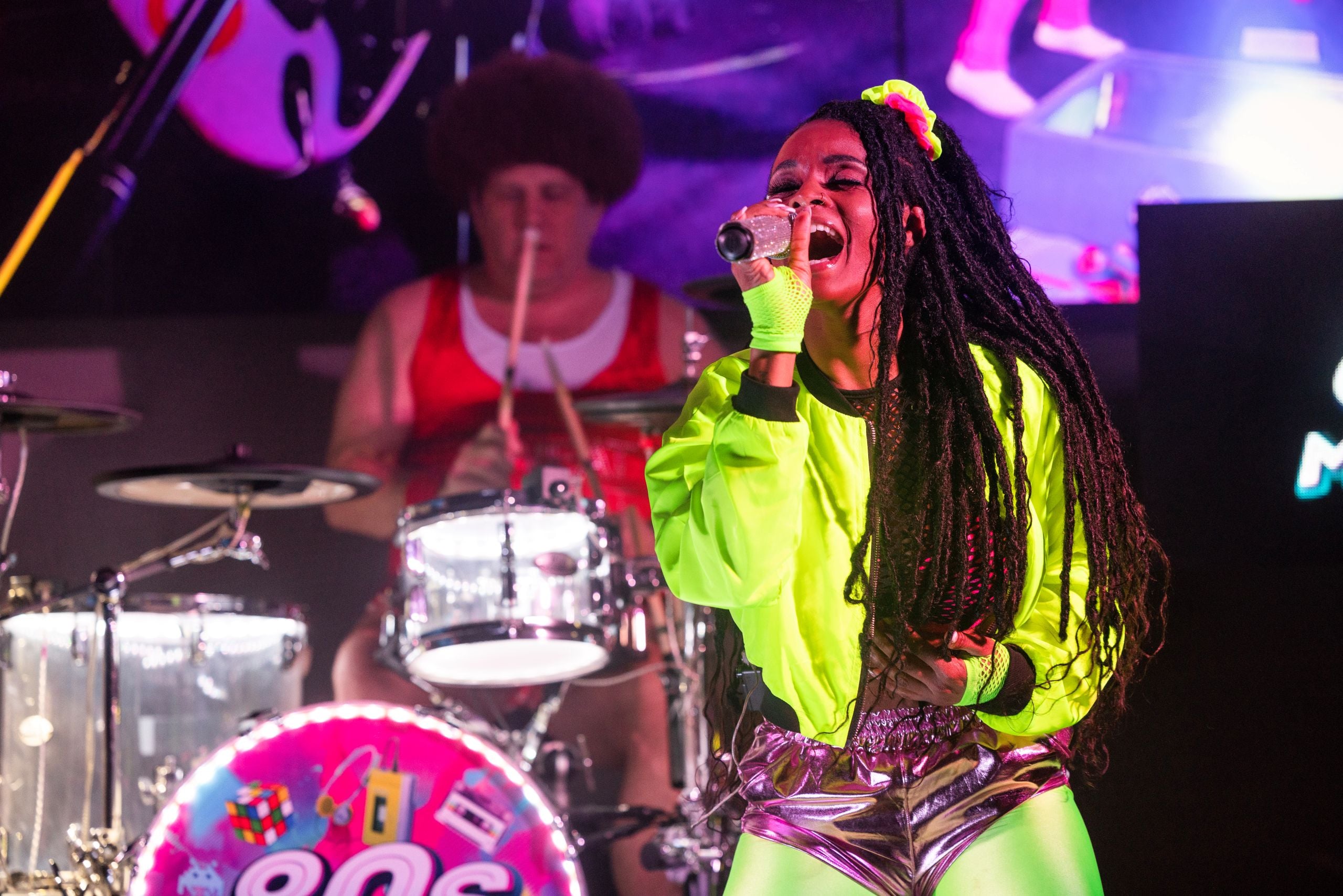 Woman in neon clothing singing