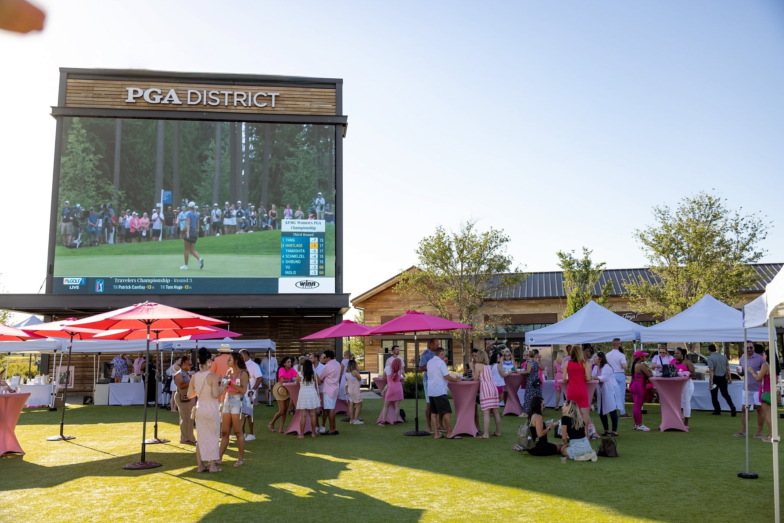 People gathered outside under umbrellas at the Rose Soiree